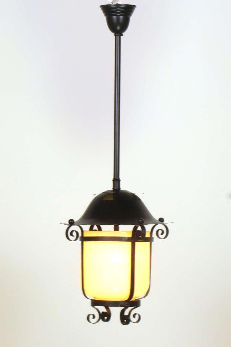 A simple yet classic Victorian lantern made of wrought iron with original opalescent glass.  It was originally an exterior gas lantern and has been electrified according to current electrical codes.  The pictures are taken lit and unlit to show how