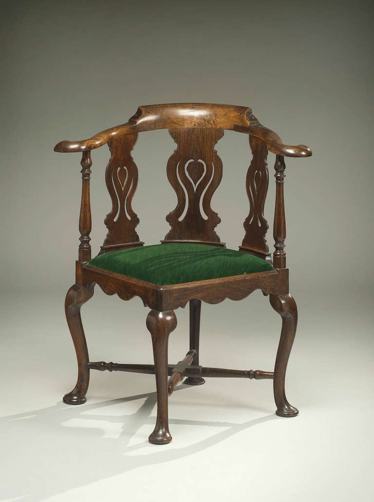 Chinese export Padouk corner armchair, the yoke-shaped top-rail continuing into scrolled arms, the three pierced splats carved with a ruyi-head, and flanked by two turned uprights, the elaborately-shaped apron over cabriole legs with pad feet joined