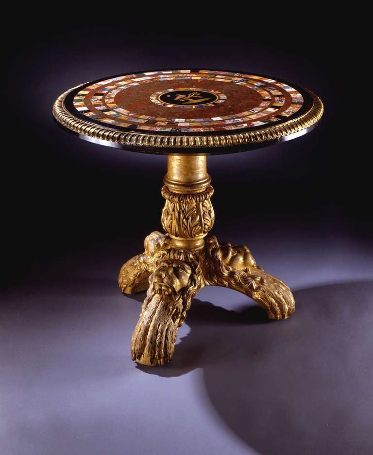the top with bold gadrooned ormolu rim, of jasper within a black marble edge and with four concentric bands of specimen marbles, the inner bordering the central Florentine pietra dura roundel of a bird perched on a tree, the base with its original
