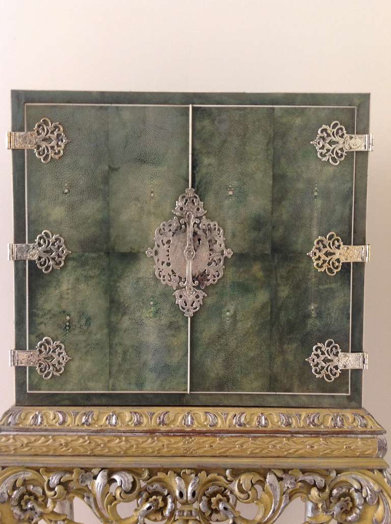 A highly unusual and decorative  shagreen and bone cocktail cabinet of neat proportions.The green shagreen cabinet  cabinet and stand in in the 17th century style .The cabinet with a pair of doors containing a maple interior and with  solid maple