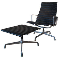 An Eames Herman Miller aluminium and leather  EA124 lounge chair and ottoman