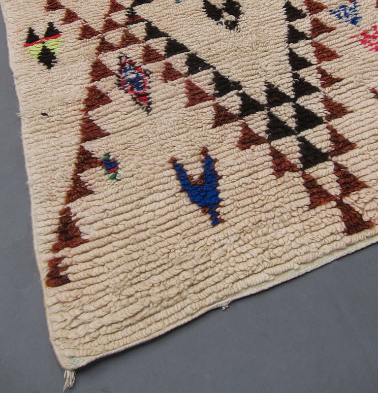 Unusual Beni Ouarain rug with brown and black lozenge lines and motifs in bright colours.  The weaver dedicated the rug to her lover by including his name in Arabic (Adel).

( Please note If you are from a country within the EU value added tax