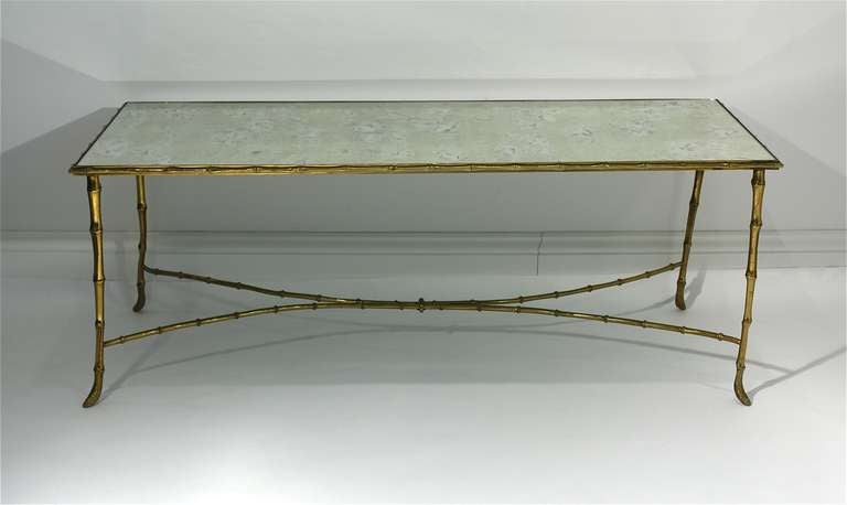 Vintage French faux bamboo coffee table with antiqued mirror top.