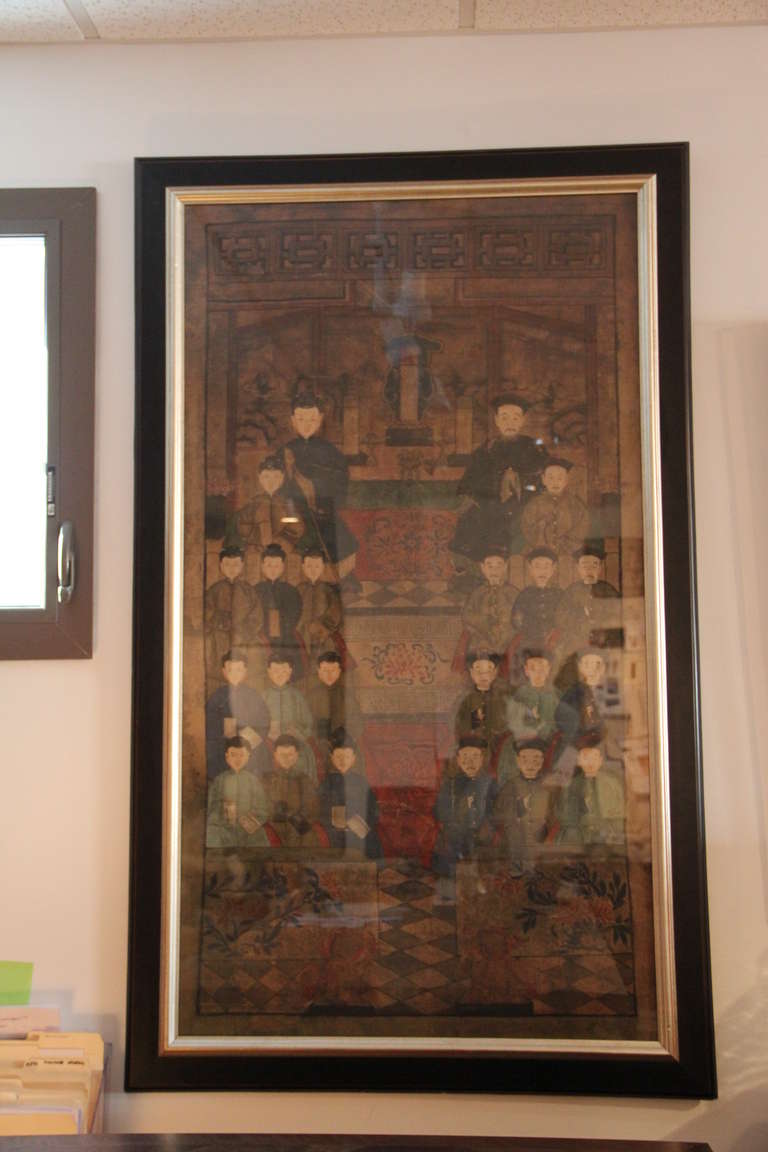 Antique Chinese family tree painted on canvas. Traditional black and silver frame.