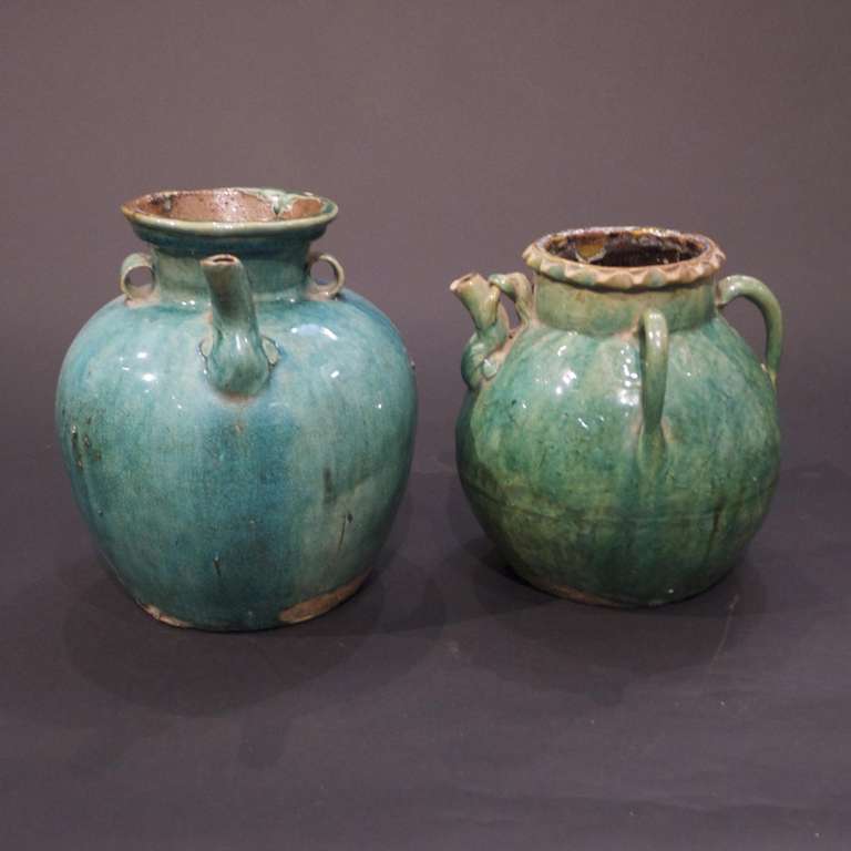 Pair of vintage green glazed mixed porcelain wine ewers of Chinese origin.