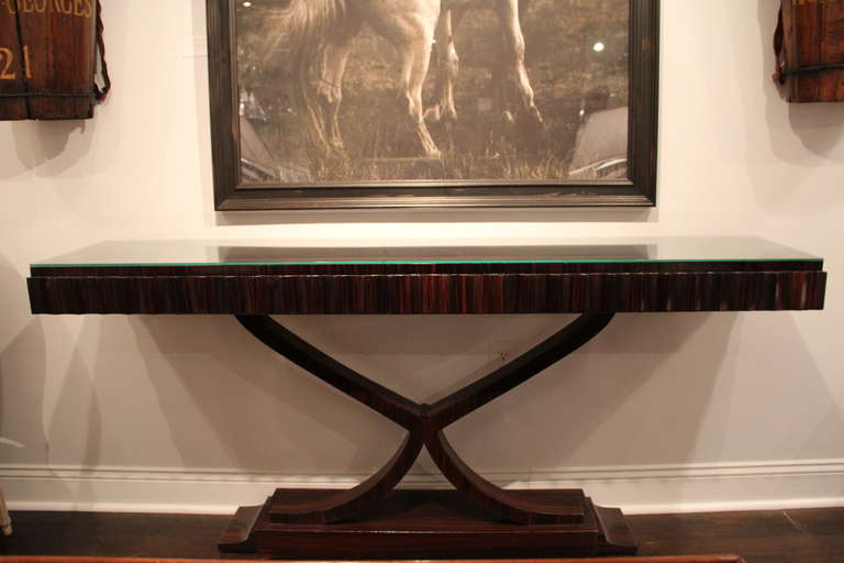 Beautiful Art Deco Macassar ebony console in the style of Ruhlmann. The console top edge is characterized by looped gadroons, while the legs meet in an elegant curved 