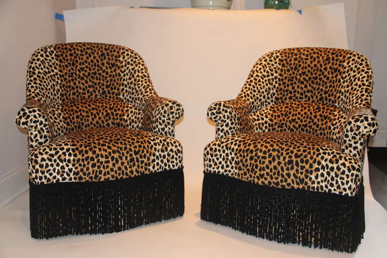 Set of two petite Napoleon armchairs, newly upholstered in luxe leopard fabric with a black boullion fringe.
