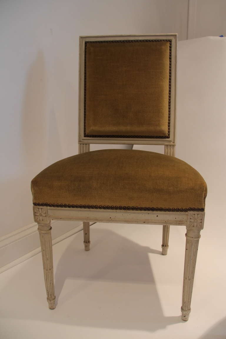 Louis XVI style side chair with antiqued white painted frame and yellow upholstery.