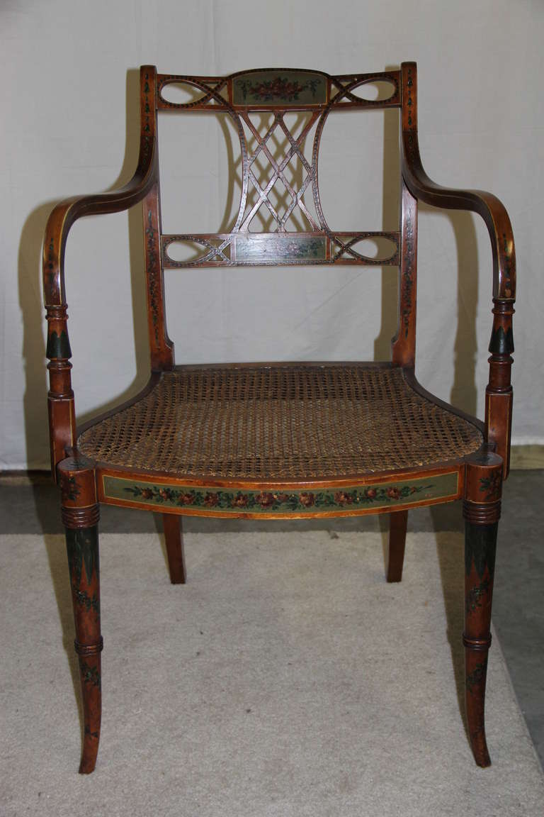 Satinwood armchair with hand-painted floral decoration and cane seat.