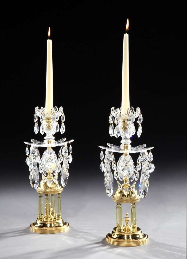 A rare and fine pair of late 18th century Adam period cut glass 'temple’ candlesticks attributed to Parker and Perry, each having Vandyke drip pans and nozzles hung with cut glass drops above a cut glass egg; on an ormolu dome supported by citron