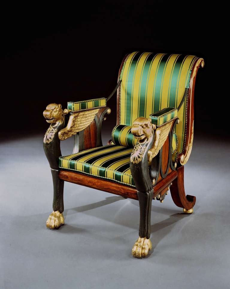 An extremely rare and possibly unique early 19th century parcel gilt rosewood and bronze painted reclining chair designed by William Pocock, upholstered in green and gold Regency stripe fabric, having a scrolled back, joined to the arms by means of