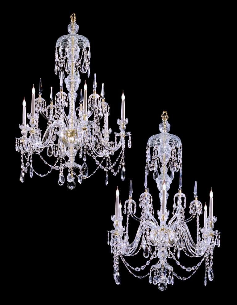 A most useful and fine quality pair of early 20th century six light, cut glass chandeliers in the 18th century Adam style. The central multi baluster stems supporting six arms divided by six kick arms with small canopies and spires, all draped with