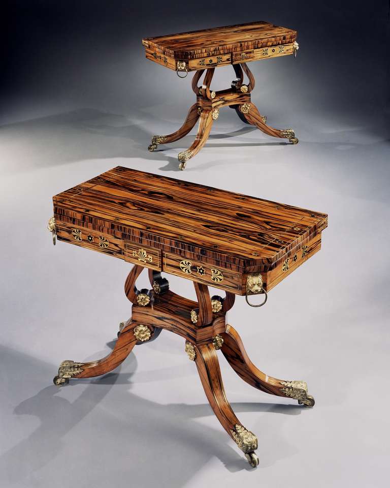 A superb quality pair of early 19th century calamander and brass mounted card tables, attributed to George Oakley, the hinged 'D' shaped tops inlaid with a border of brass stars, the baize lined interiors about a brass palmette inlaid frieze with