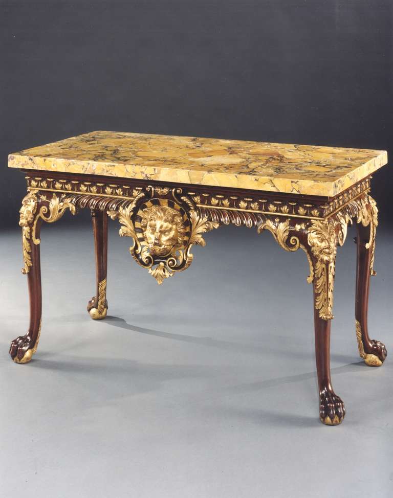 A magnificent and highly important early 18th century parcel gilt carved mahogany side table retaining most of the original gilding, having a wonderful replaced 18th century ‘yellow Sienna’ marble top above a moulded frieze, carved with acanthus