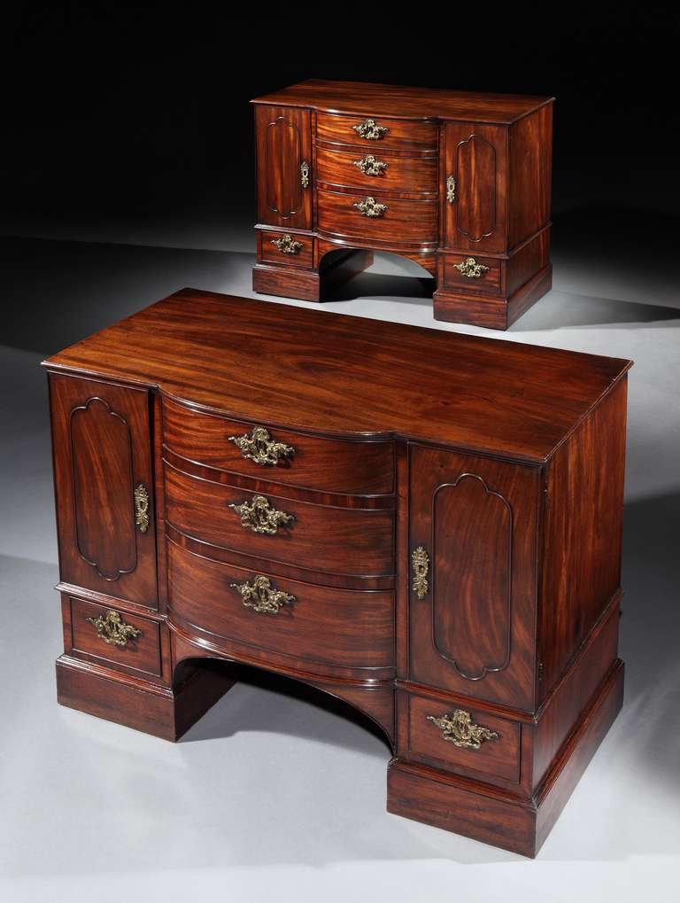 A fine pair of mid 18th century Chippendale period mahogany commodes attributed to Wright & Elwick, each having a rectangular top with bow fronted centre and moulded edge above three graduated bow fronted central drawers, retaining the original