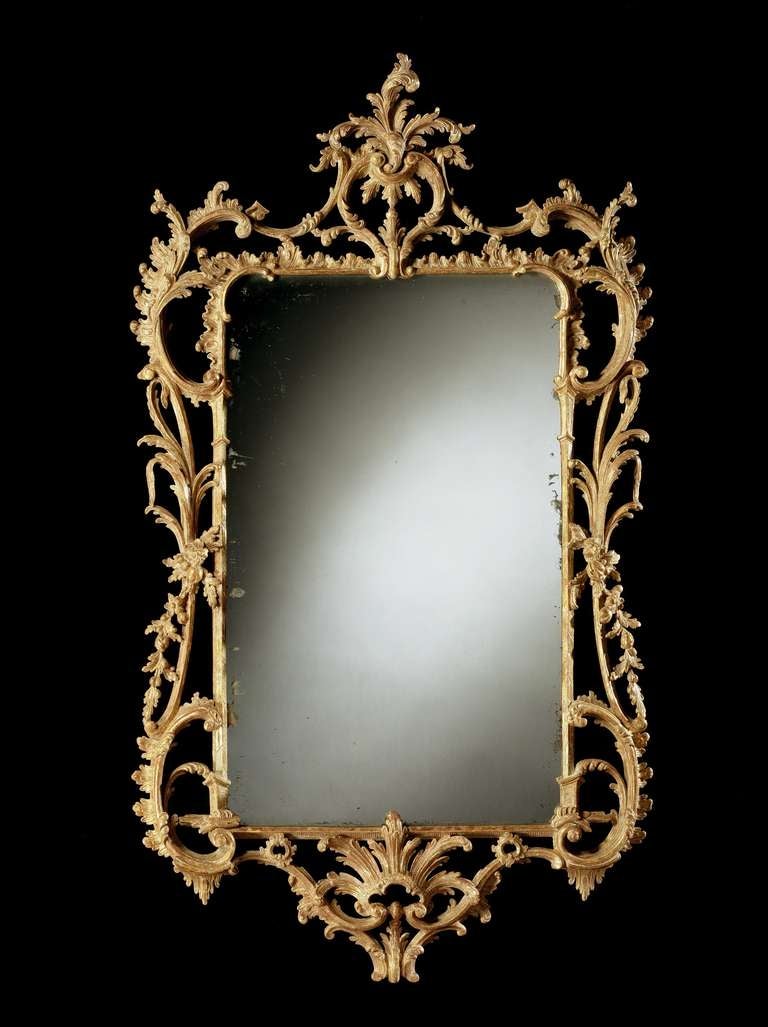An important mid 18th century Chippendale period carved giltwood mirror of large proportions, retaining most of the original gilding and the original rectangular plate within a chinoiserie column and cabochon ruffled frame, having pierced foliate