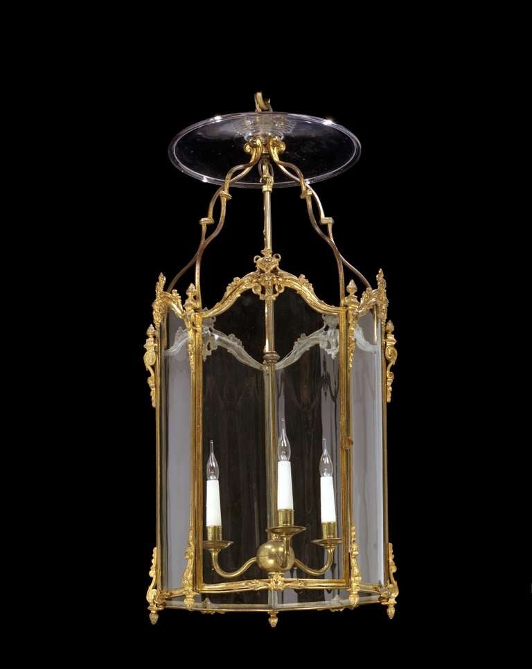 A fine early 19th century pentagonal brass lantern, having an ornate corona with later smoke cowl above shaped arm supports and five serpentine shaped sides with shaped leaf cresting; terminating in truss feet. 

Provenance: By repute Lulworth