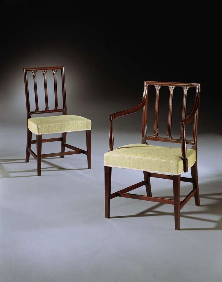 A fine set of eight late 18th century mahogany dining chairs consisting of six side chairs and two armchairs, the rectangular backs with vertical splats and stuffed seats, on square tapering legs united by H- frame stretchers.