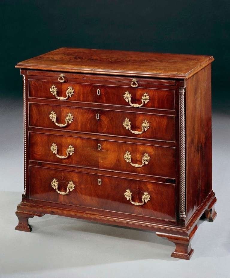 A charming mid 18th century Chippendale period straight fronted chest of drawers. The crossbanded top with moulded edge above brushing slide and four graduated drawers unusually having aromatic cedar lining and having original elaborate swan-neck