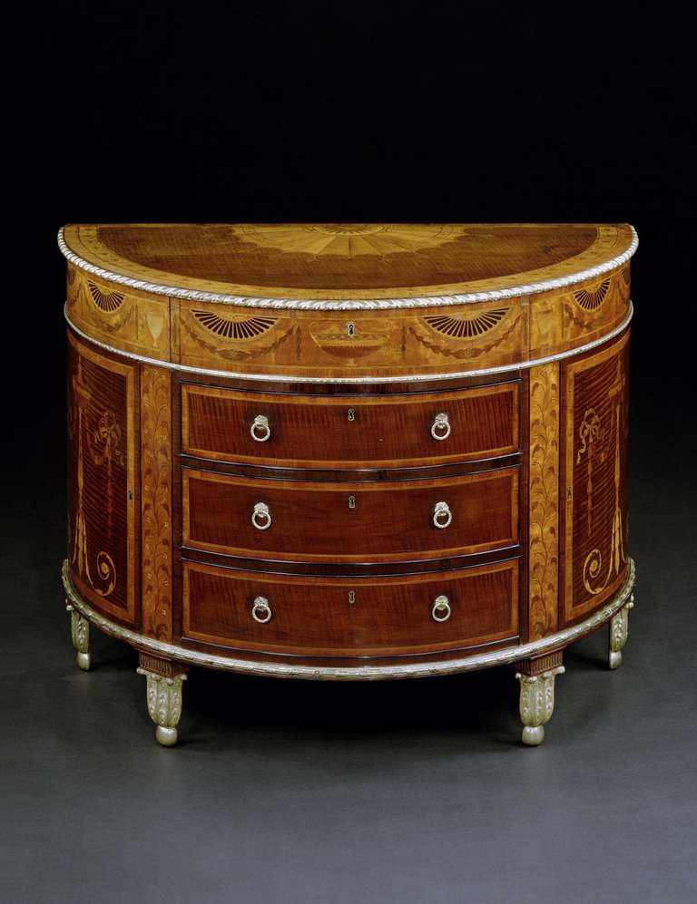 An extremely fine and very important late 18th century harewood ormolu mounted demi-lune marquetry commode attributed to Mayhew and Ince, and the mounts to Diedrich Anderson, the semi-circular top mounted with a gadrooned ormolu banded edge and