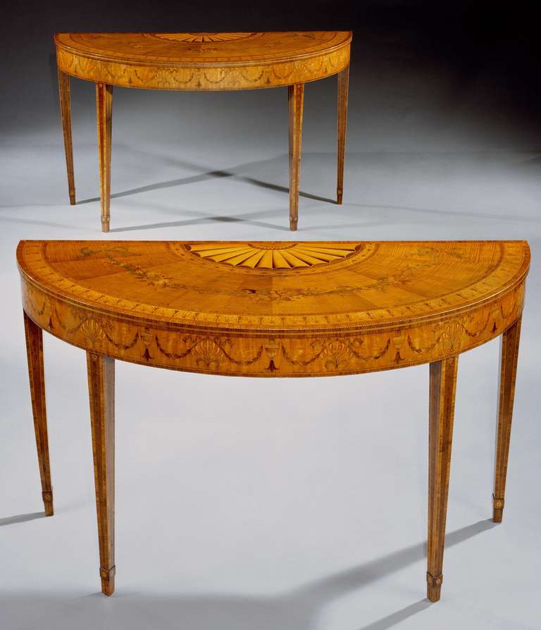 An outstanding and extremely rare pair of Irish late 18th century Adam period sycamore, satinwood and marquetry side tables by William Moore of Dublin, each having semi elliptical top with cross banded edge and chevron stringing finely banded with