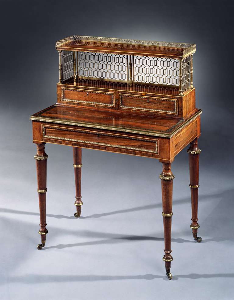 An extremely rare and superb quality pair of early 19th century Regency ormolu mounted rosewood bonheur du jour attributable to John McLean. The lift-off tops fitted with two drawers with egg and dart beading with pierced panels of gilt brass and a