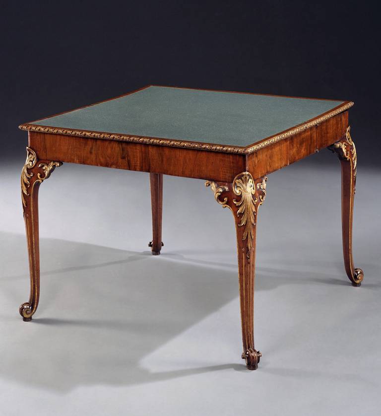 An outstanding mid 18th century Chippendale period carved walnut and parcel gilt card table attributed to Paul Saunders, retaining most of the original gilding, having a dark green baize lined fold-over top with ribbon and flower carved edge on a
