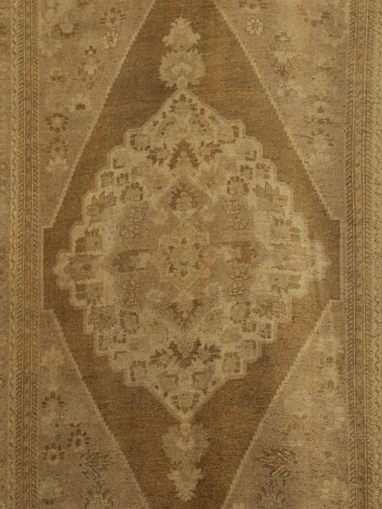 Oushak rugs such as this vintage rug are highly decorative & desirable for their pale colors. 
This oushak,  subdued palette in soft vison, light brown, ivory and bone colors whose pleasing qualities are enhanced by their particularly soft and