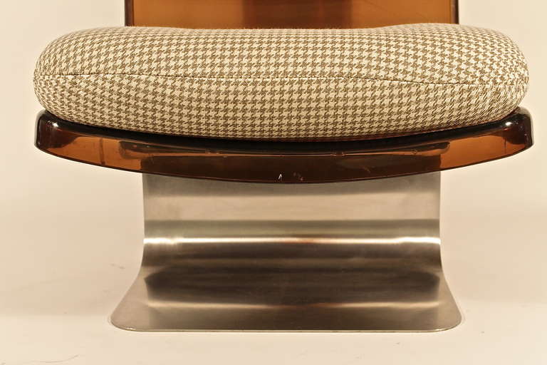 Lounge Chair from 1970 produced by Grosfillex, France. Smoked plexiglass shells with cushions and heavy curved steel base.