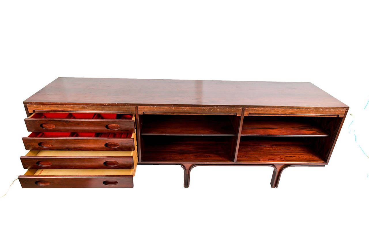An elegant gianfranco frattini sideboard made in rosewood with 3 doors and  4 drawers that have the original felt. This sideboard presents very characteristic bended legs. gianfranco frattini (1926- 2004) was an Italian architect and designer. He