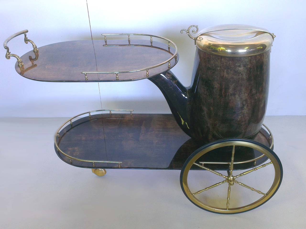 Amazing bar cart designed  by Aldo Tura in 1950
Made  in wood covered brown painted parchment , polished brass