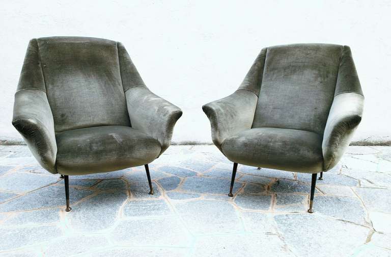 pair of big 50's armchairs, upholstery covered with green velvet, 
black lacquered brass feet