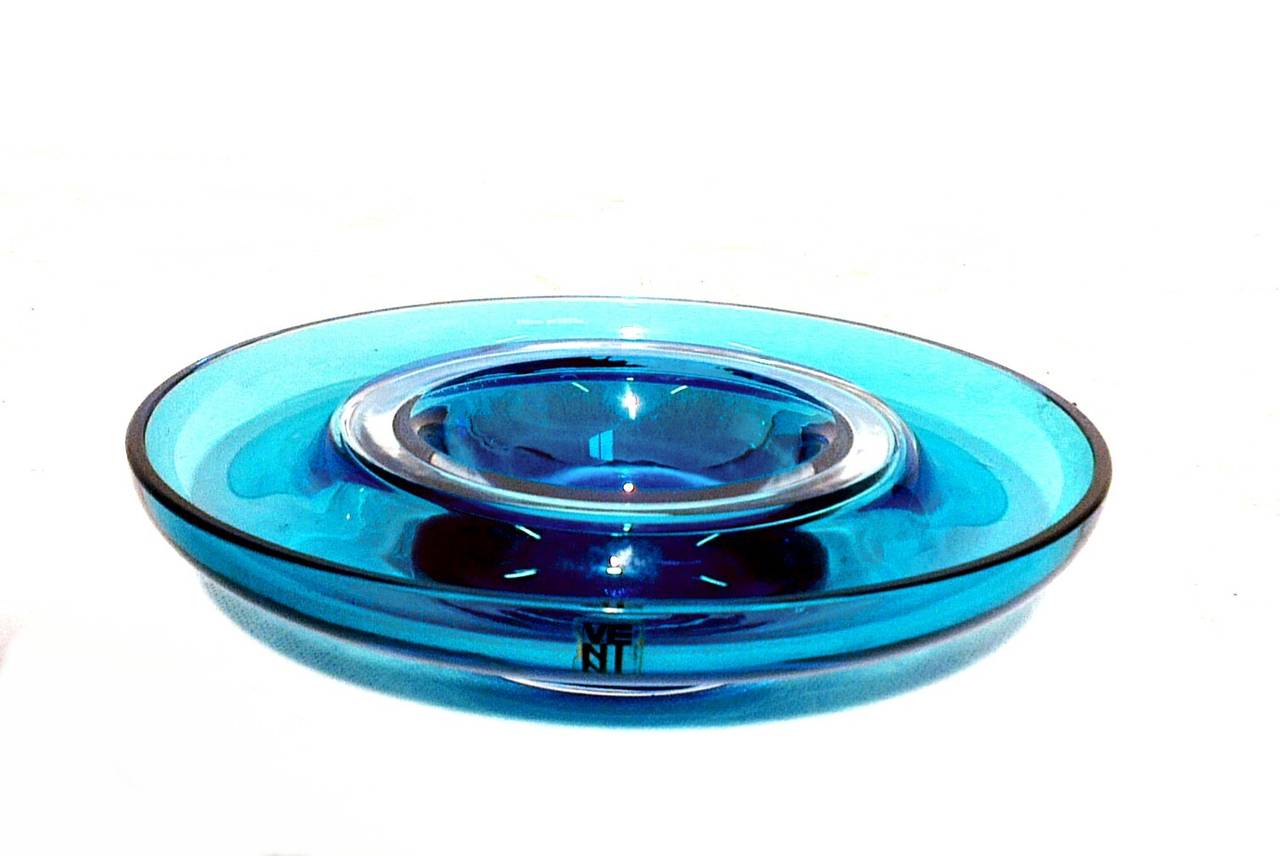 Beautiful ashtray by Venini, signature engraved at the base and label of the factory. 
Blue glass with central circle transparent glass.
