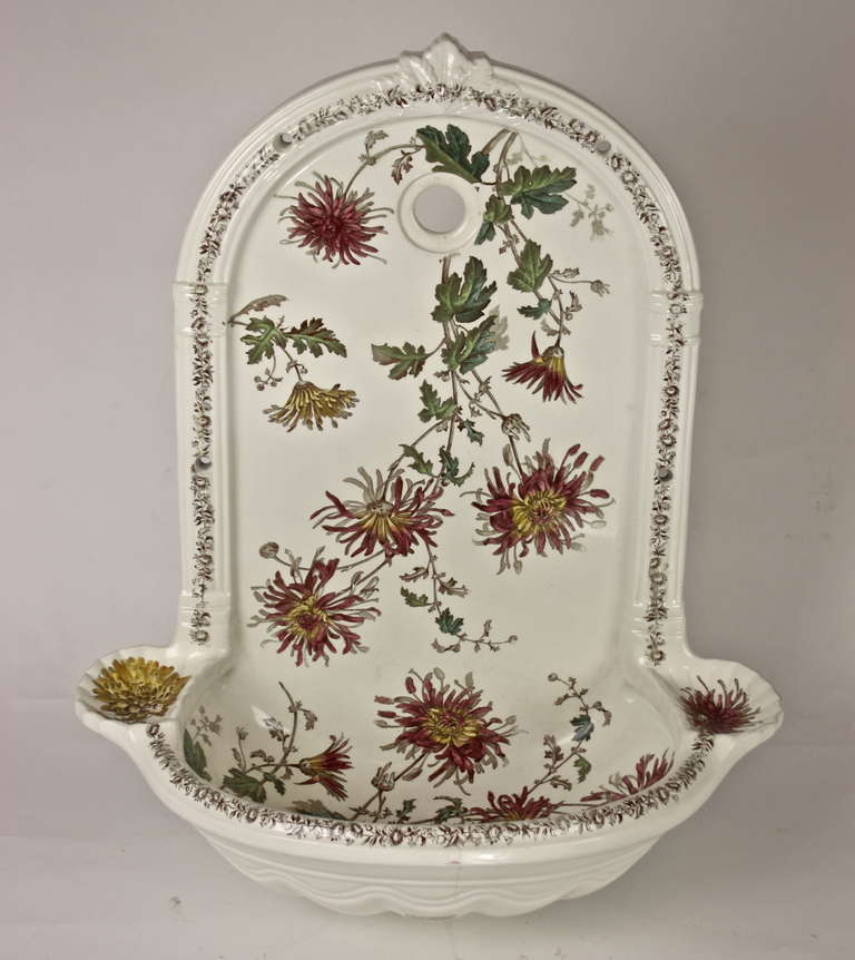 Beautifully shaped and with flowers decorated sink. Manufactured by ‘Etablissement Porcher Paris - Revin’, a company founded in 1886 and known for its art deco lavatories.