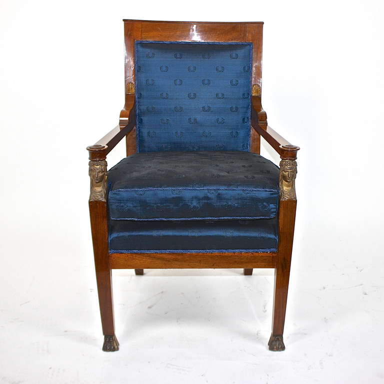 An impressive Napoléonic Empire walnut armchair, attributed to ménuisier-ébéniste François-Honoré-Georges Jacob-Desmalter (1770–1841), a similar piece part of the collection of the Victoria & Albert Museum (Museum number: W.2C-1987). Notably