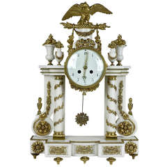 A Louis XVI Ormoulu and White Marble Mantel Clock