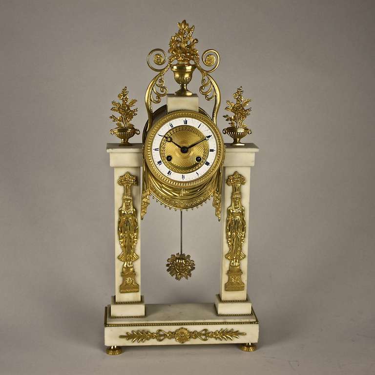 A French Empire Ormoulu and White Marble Mantel Clock