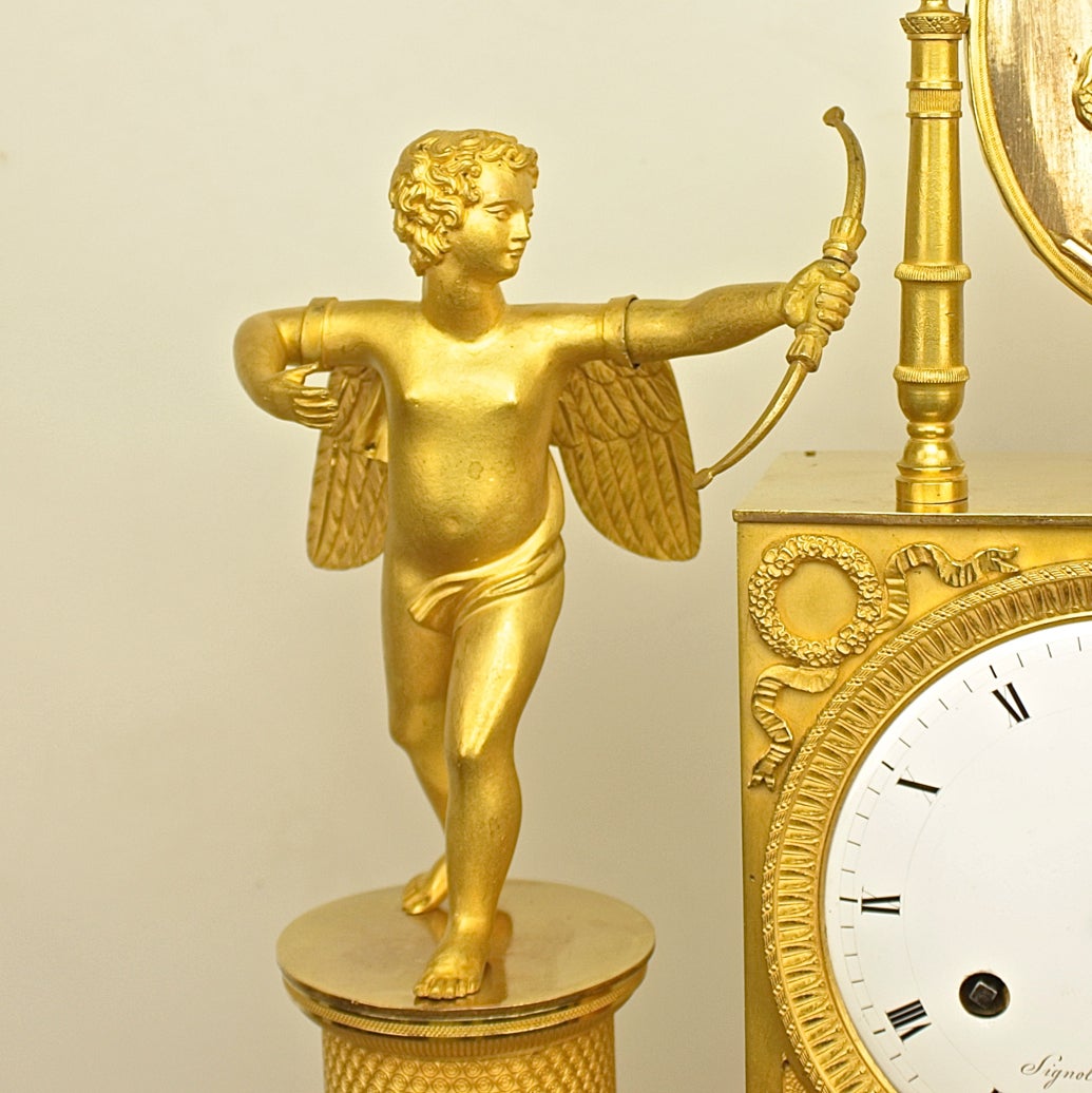 A superb and very large Empire ormolu mantel clock in perfect working order and cleaned and pristine condition, retaining its original ormolu gilding with burnished and matte finishes. 
The rectangular drum case flanked by an artist lady dressed in