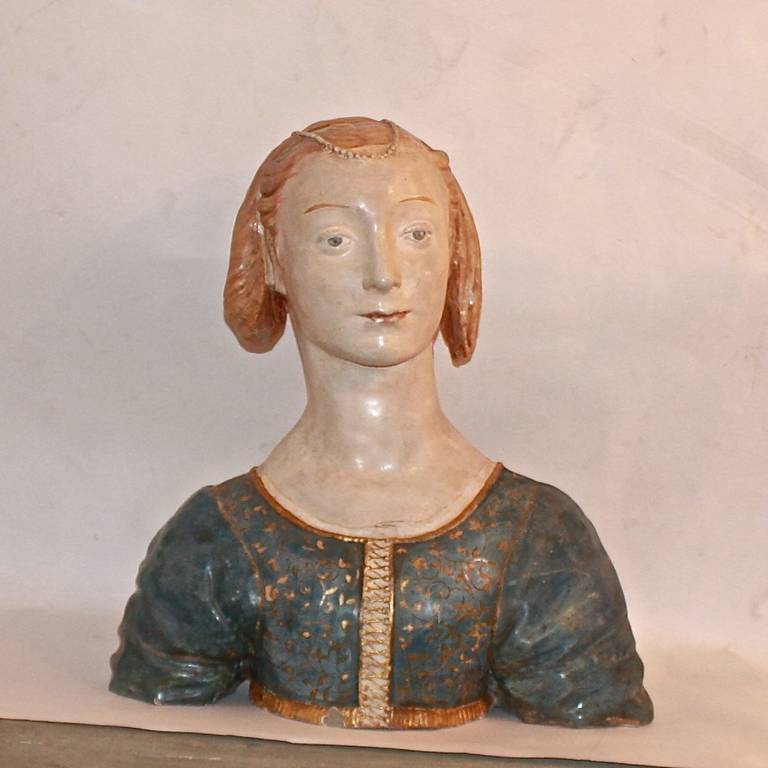 A stone cast depicting Marietta Strozzi, a copy of the original marble bust attributed to Desiderio da Settignano (1428/31 – 1464), probably made at the end of the 19th century, interpretating the monochrome marble into a rich polychrome decoration.