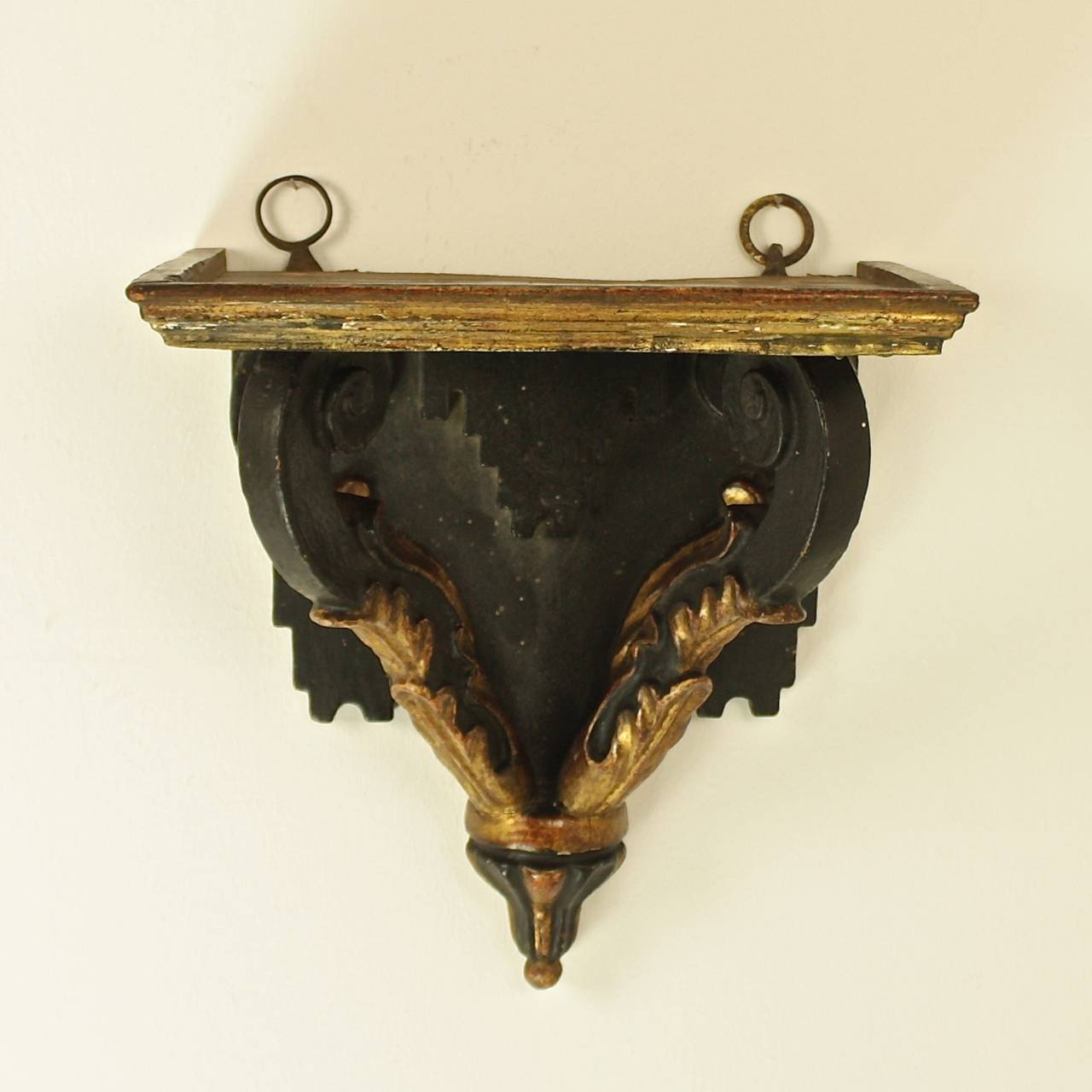French Provencal wall bracket from about 1720 with a rectangular shaped top above scrolled and acanthus leave decorated supports terminating in a gadrooned shaped finial.