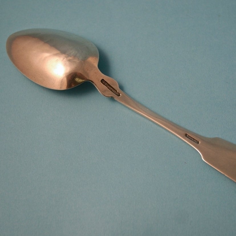 Nantucket coin silver spoon, circa 1840s.
Maker: James Easton 2nd.
Mark: J. Easton 2nd. Nantucket.
Engraved on handle: Edward Payson Folger born March 15th 1846.
Length: 8 inches.

Condition: Tip wear and dents to bowl.

 
Note:
The