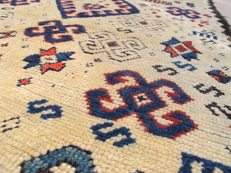 With a rugged construction of soft thick pile and coarse dark weft, this uncommon Zakatala prayer rug displays the classic rustic construction and graphic boldness that make these North Caucasian pieces so popular. Balanced against the