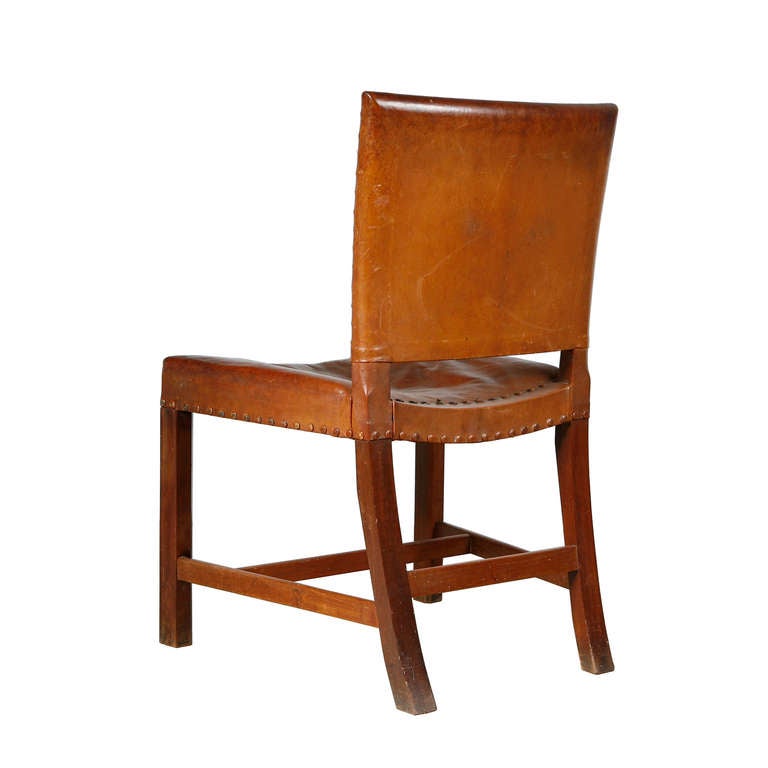 Set of twelve Kaare Klint 'Red' chairs. Designed in 1927 for the Museum of Art and Design's lecture room, Copenhagen. Cuban mahogany with original Niger leather. Early version with leather-covered studs. Made by Rudolf Rasmussen, Copenhagen.