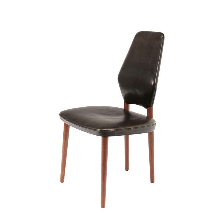 A set of 4 dining chairs in teak with original black leather upholstery. Designed by Helge Vestergaard Jensen in 1958. Made by cabinetmaker Peder Pedersen, Denmark.