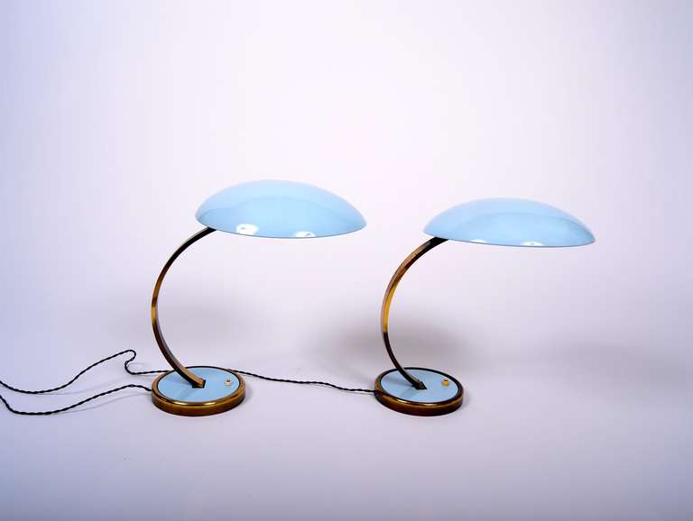Christian Dell Kaiser Idell model 6751 brass Desk Lamp

Both lamps have been gently restored. Light Blue new laquer on base and shade. Rewired with black fabric cord.

weigth ca 5 kilos each massive brass
