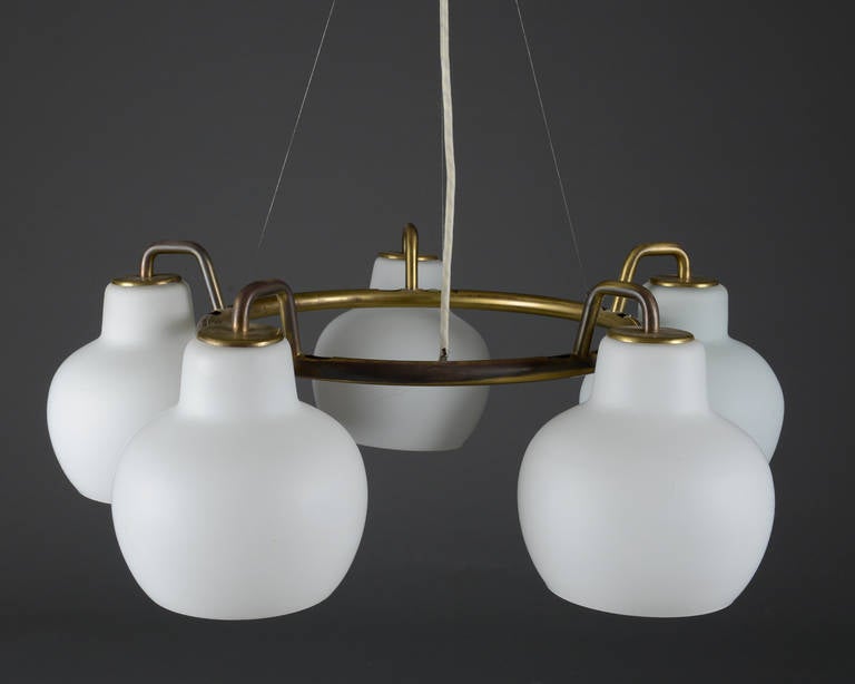 Vilhelm Lauritzen 1894-1984. Christiansborg / B&G ring chandelier, brass with five matte opal glass shades. Inner brass ring, Ø 40 cm, total Ø with shades approx. 70 cm. 

Made in Denmark by Louis Poulsen