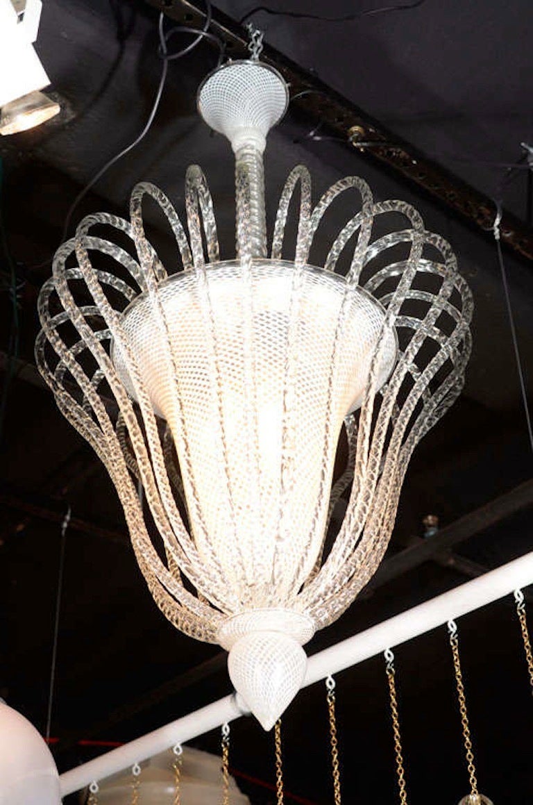 A rare and early Art Deco lantern from the 1930s attributed to Venini. The vase shape shade, bottom finial and ceiling canopy are hand blown clear and white stripe glass in a lattice pattern known as reticello produces in many Venini designs of the