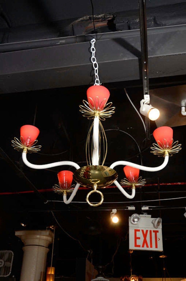 A charming Italian, 1950s opaline glass and brass chandelier. The five arms and central rod are white opaline glass and the shades are in cranberry red opaline glass. All handblown in Murano, Italy. Includes matching cranberry opalice ceiling canopy