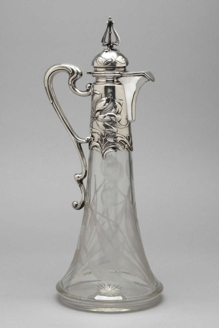 A rare and unusually large claret jug.  The sterling mount chased with flowers and the original glass finely engraved with tulips and leaves.  Austrian circa 1885.  Fully hallmarked.  This jug will hold in excess of 2 bottles, possibly 3.

Ht 18