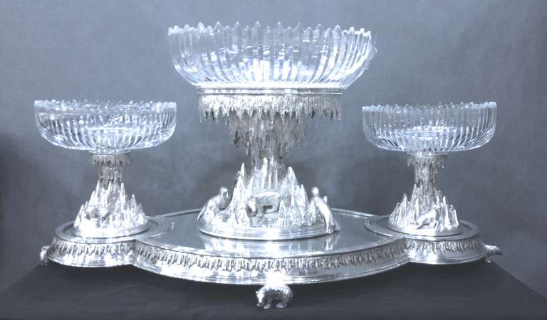 An extremely rare plated garniture chased with polar bears on the original mirror plateau.  English, circa 1875.  Complete with 3 cut glass dishes that simulate an ice floe.  This is a design that was made in a very limited number, of which few have